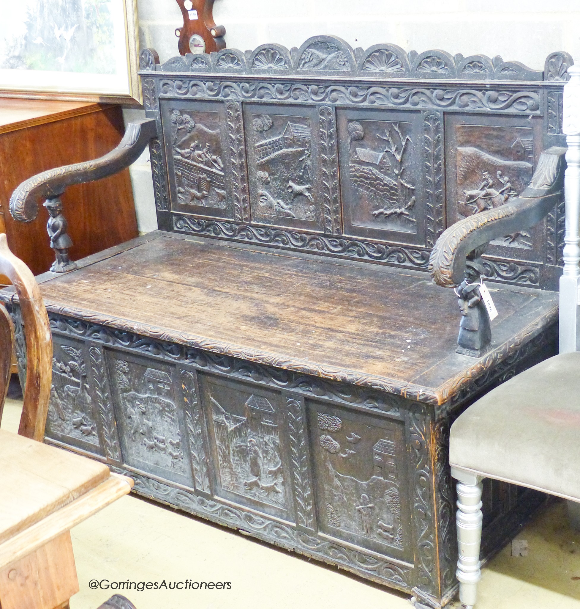 A late 19th century Flemish carved oak box seat settle, W.140cm D.62cm H.105cm